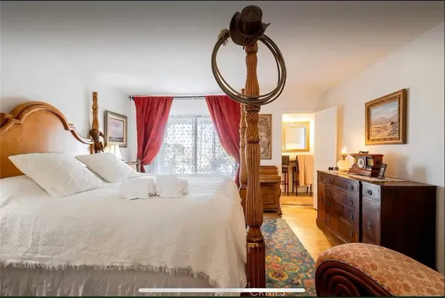 a bedroom with a bed and a night stand