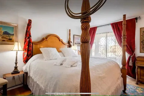 a bed room with a bed and a chandelier