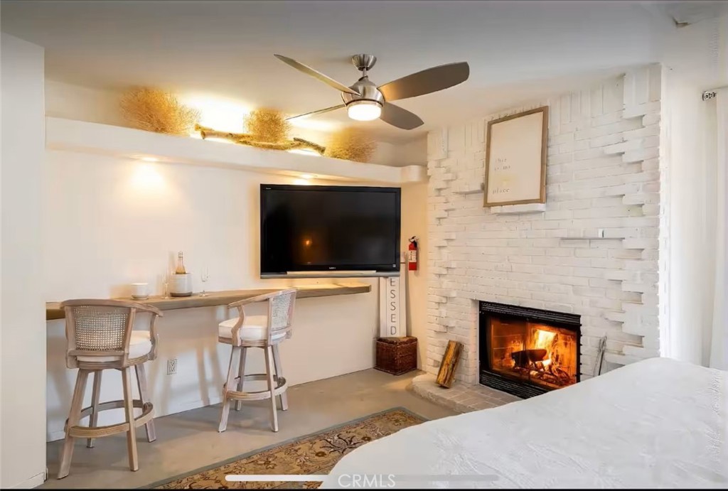 70138 Sullivan Road Twentynine Palms, CA 92277 - Photo 16 of 68 a living room with furniture a flat screen tv and a fireplace