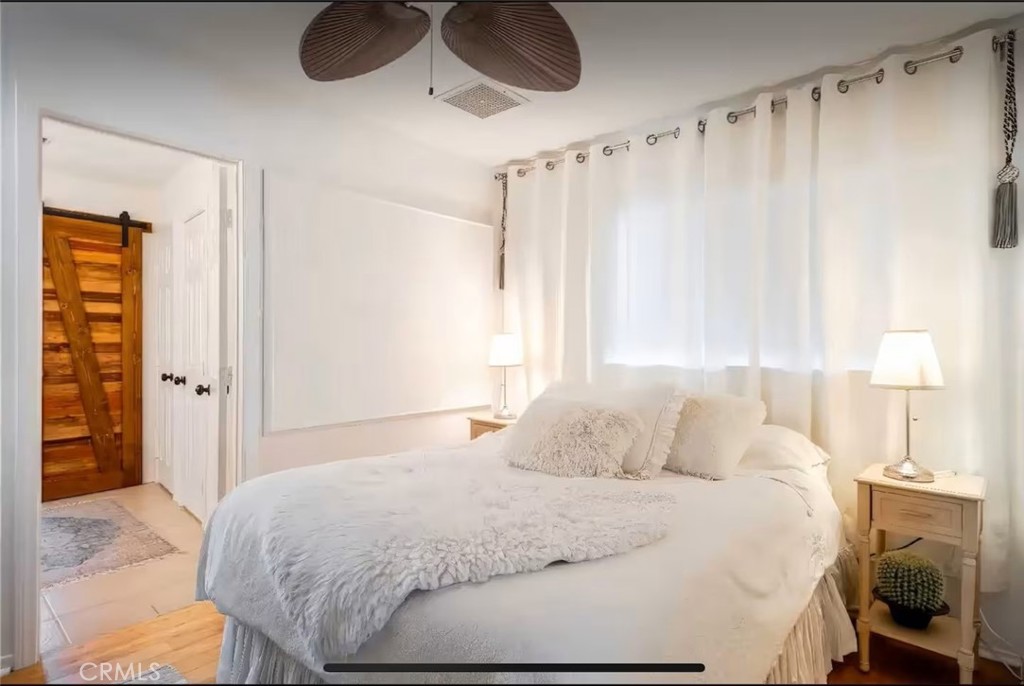 70138 Sullivan Road Twentynine Palms, CA 92277 - Photo 20 of 68 a bedroom with a bed and a chandelier