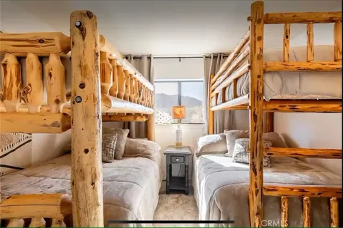 a room with table chairs and a large window