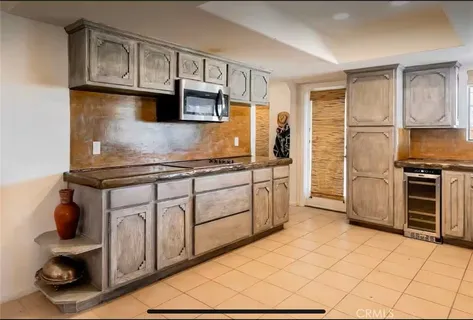 a kitchen with stainless steel appliances granite countertop a sink a stove a refrigerator a counter top space and cabinets