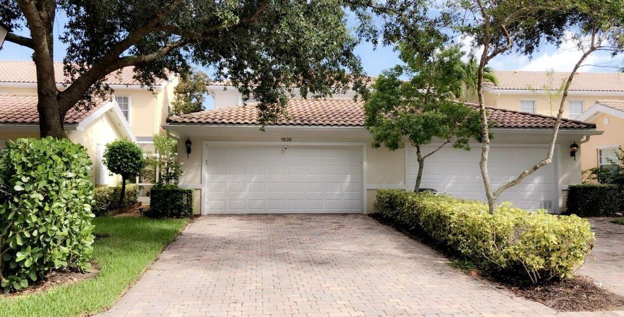 1836 Jeaga Drive Jupiter, FL 33458 - Photo 18 of 20 a front view of a house with a garden
