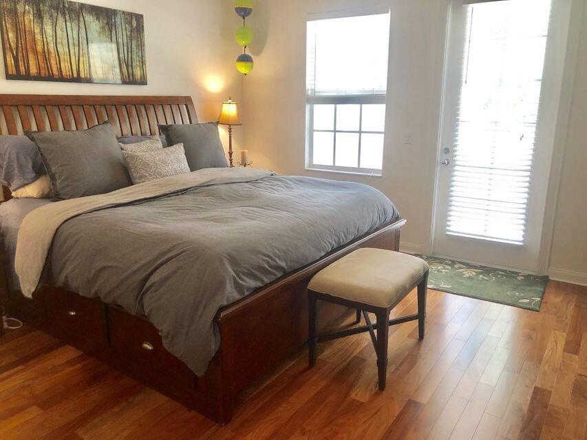 1836 Jeaga Drive Jupiter, FL 33458 - Photo 7 of 20 a bedroom with a bed and window