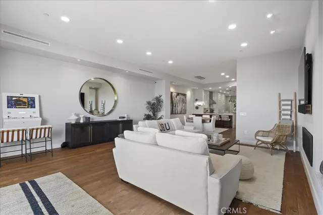 a living room with baby crib furniture and a wooden floor