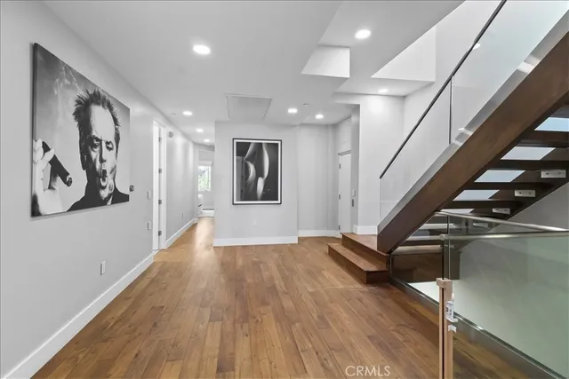 a large bedroom with bed and a large mirror