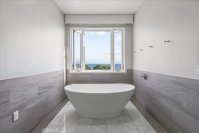 a spacious bathroom with a double vanity sink a large mirror and a shower