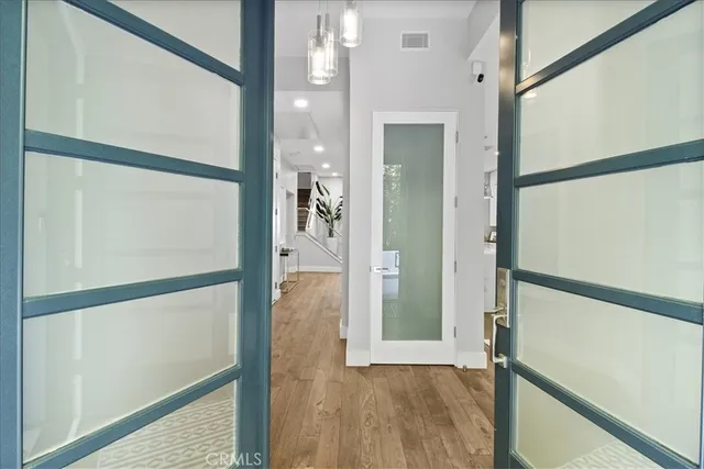 a view of empty room with wooden floor