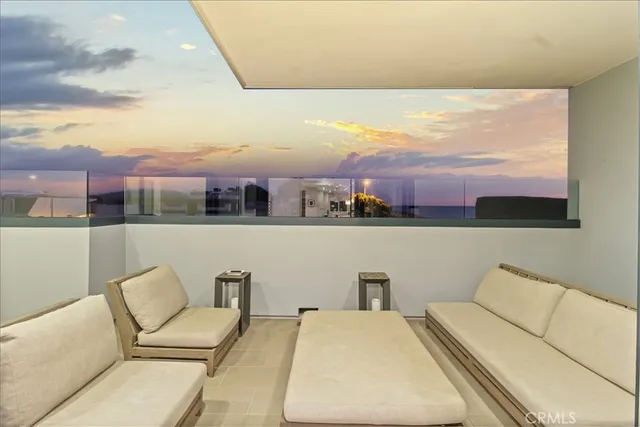 a view of a roof deck with table and chairs