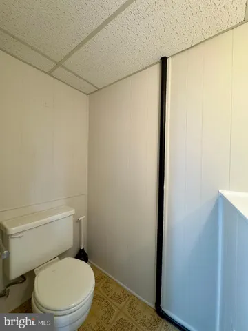 a white toilet sitting next to a shower