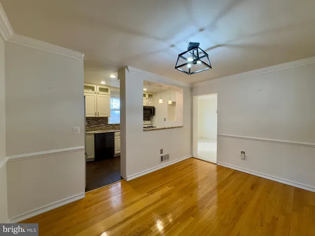 a view of a kitchen with wooden floor and a sink