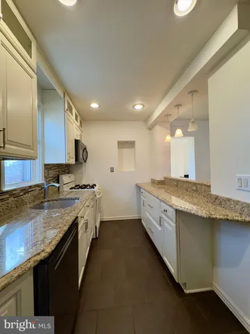 a large kitchen with a stove and cabinets