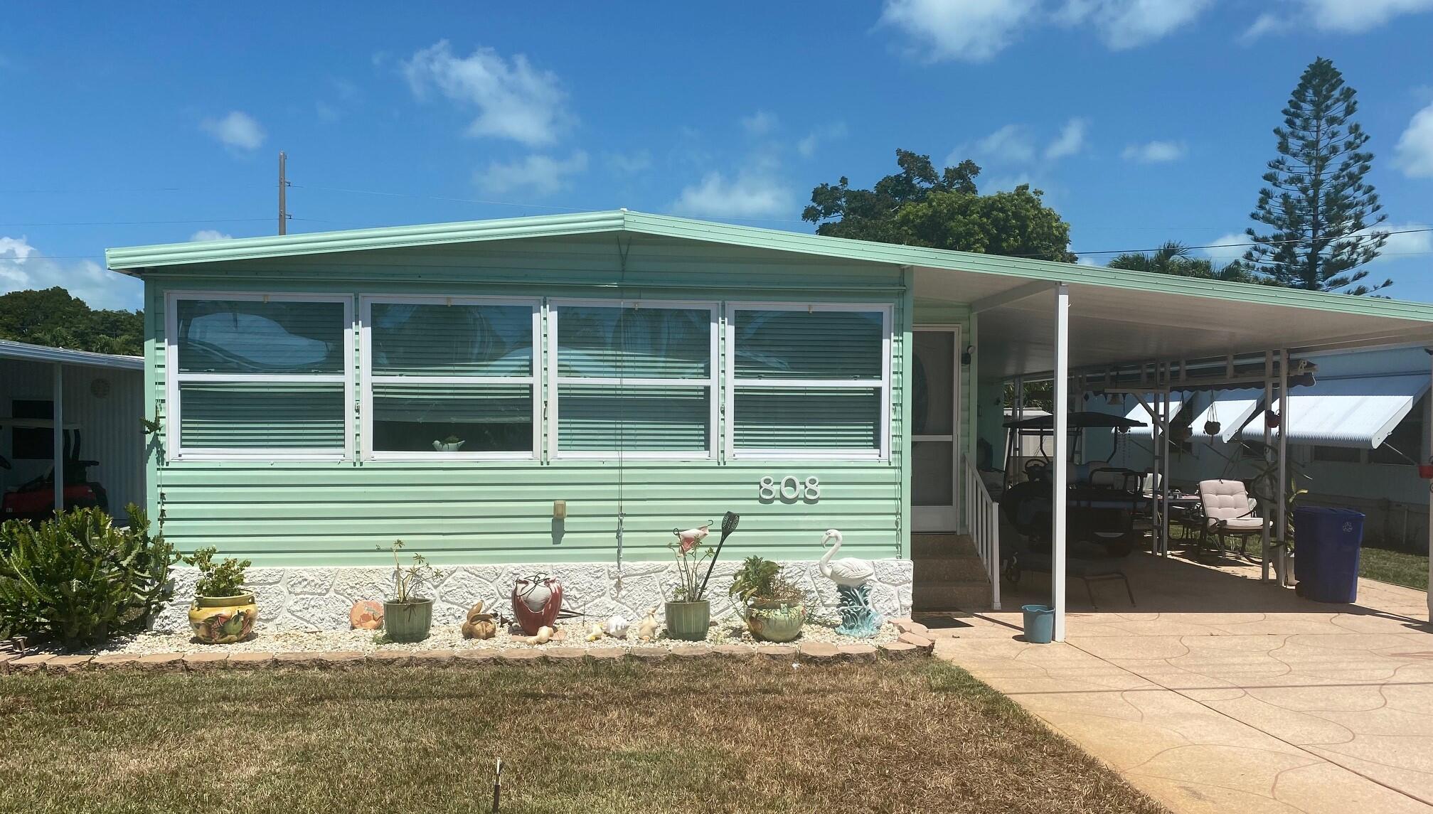808 South Silver Circle Key Largo, FL 33037 - Photo 1 of 24 a front view of a house with a yard