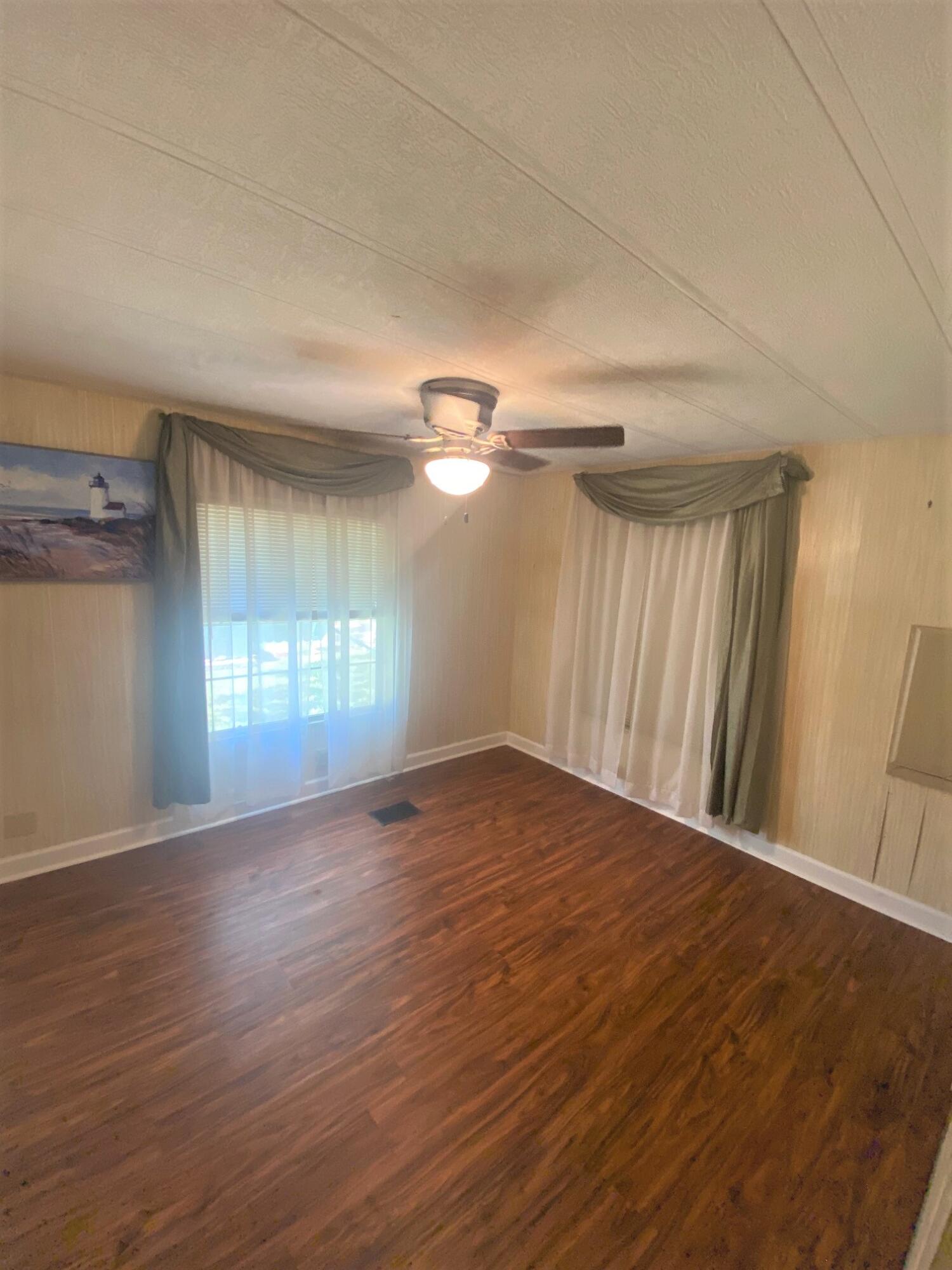 808 South Silver Circle Key Largo, FL 33037 - Photo 13 of 24 wooden floor in an empty room with a window