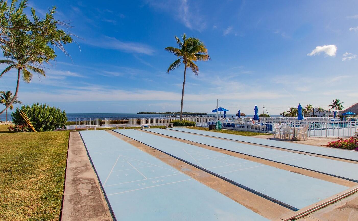 808 South Silver Circle Key Largo, FL 33037 - Photo 17 of 24 a swimming pool with a table and chairs