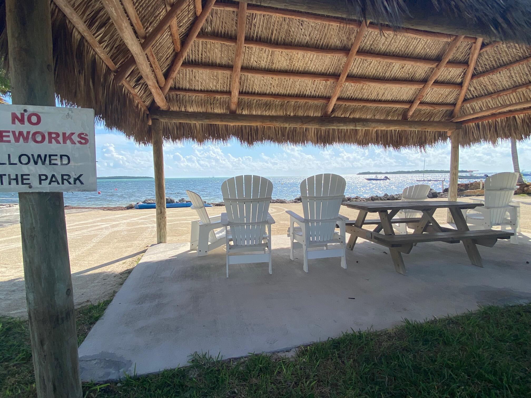 808 South Silver Circle Key Largo, FL 33037 - Photo 18 of 24 a view of a patio with table and chairs with wooden floor
