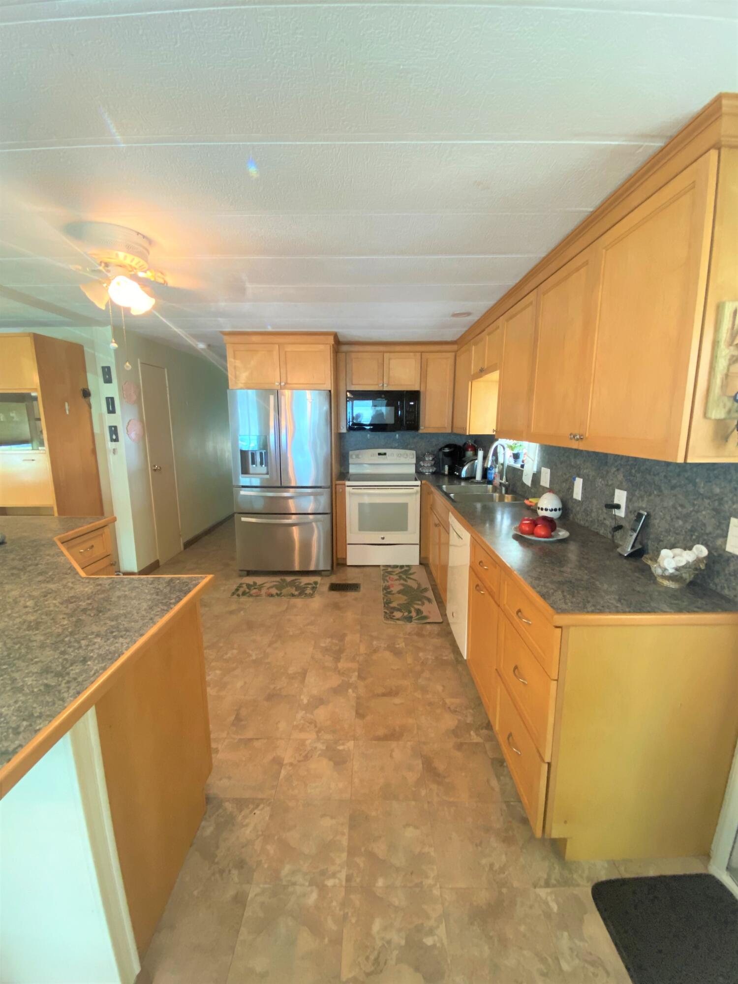 808 South Silver Circle Key Largo, FL 33037 - Photo 5 of 24 a large kitchen with stainless steel appliances a large counter top a stove and a refrigerator