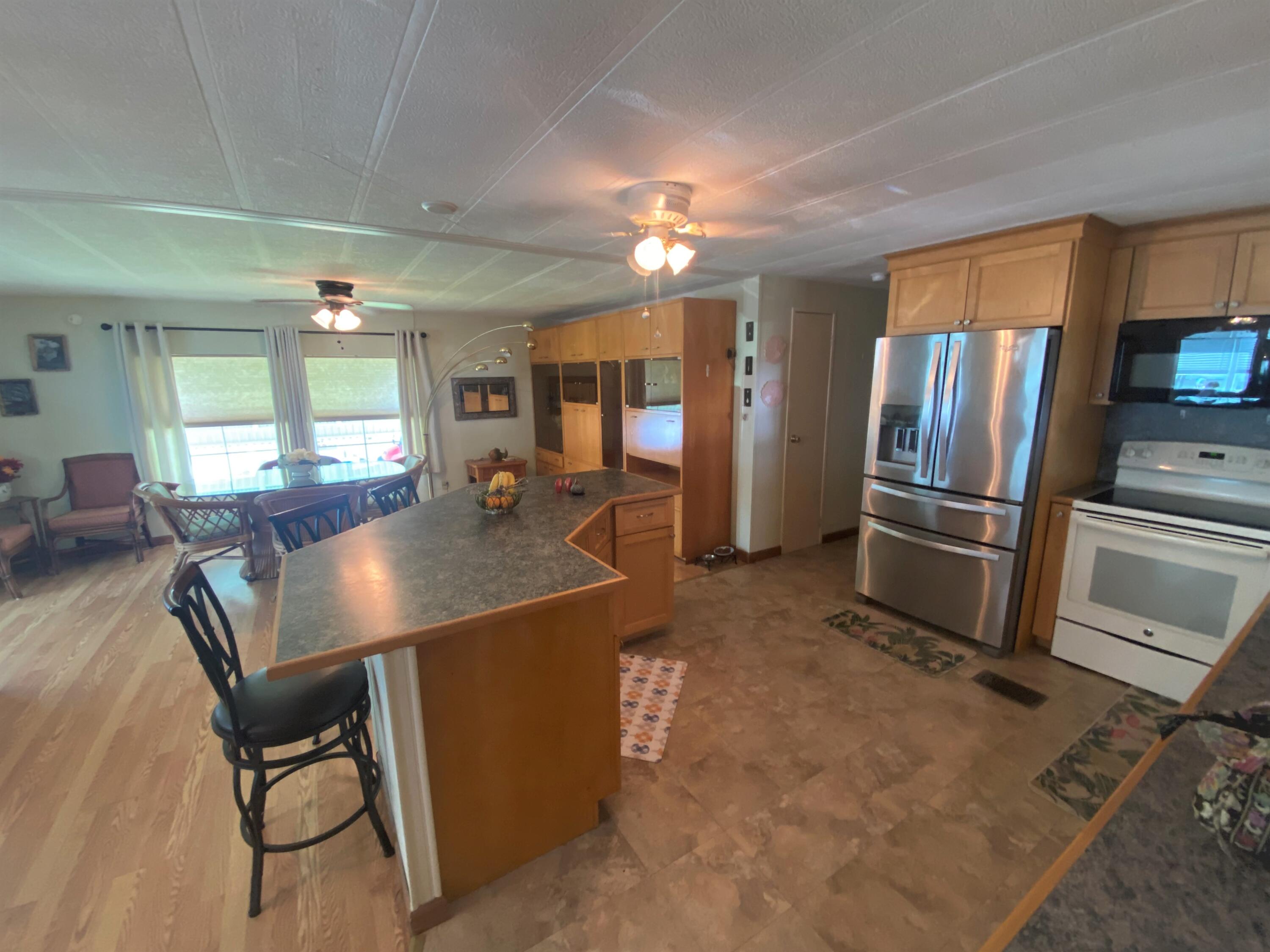 808 South Silver Circle Key Largo, FL 33037 - Photo 7 of 24 a view of a kitchen with kitchen island a counter top space appliances and a dining table