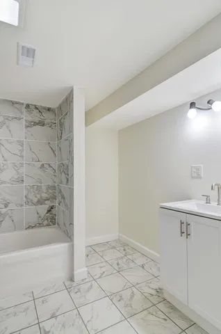 a bathroom with a sink a toilet and bathtub