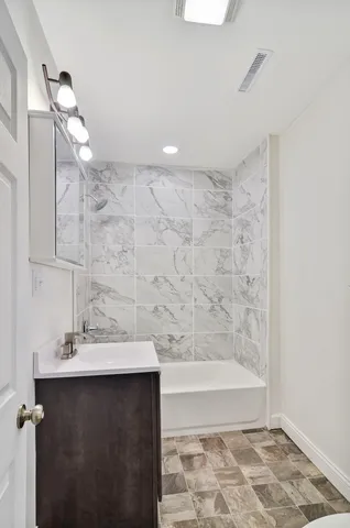 a bathroom with a bathtub and a sink