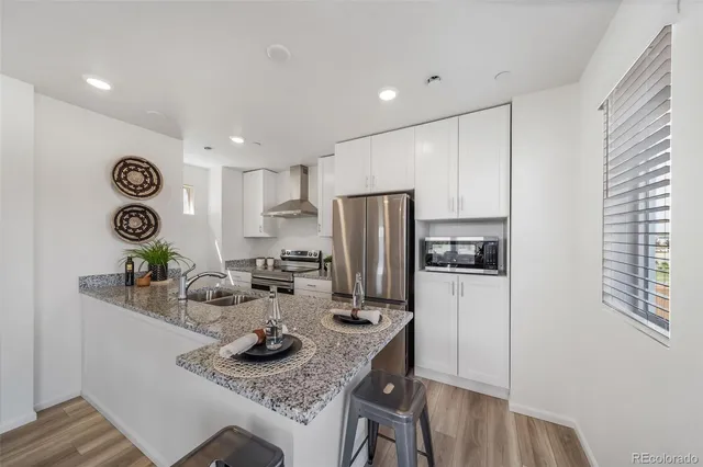 a kitchen with refrigerator and stove