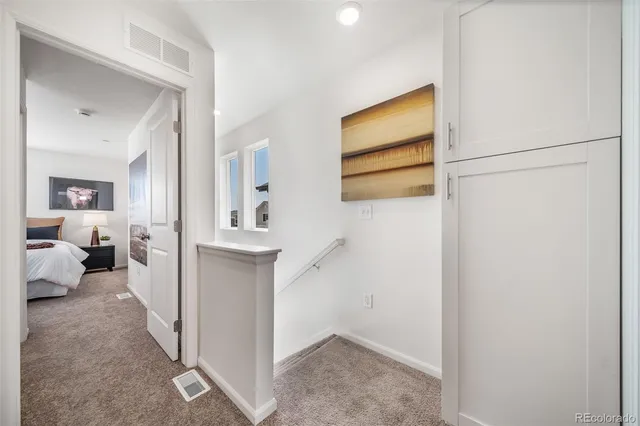 a bedroom with a bed and painting on the wall