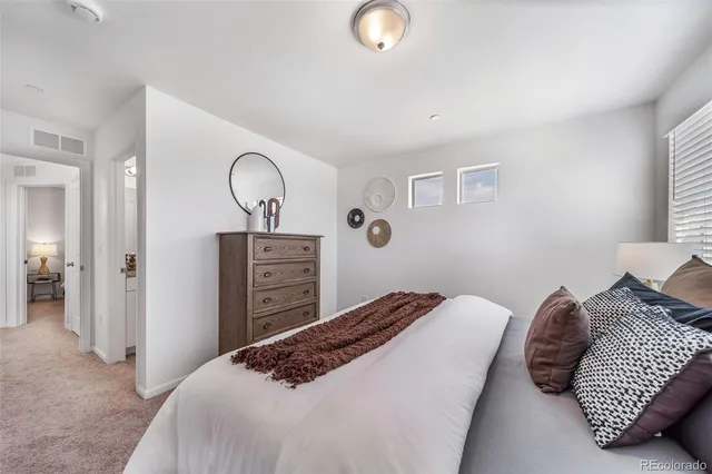 a bedroom with a bed and a night stand