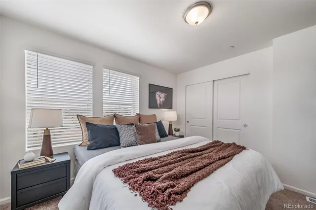 a bedroom with a bed and a lamp