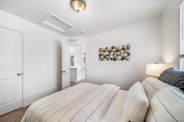 a bedroom with a bed and a night stand