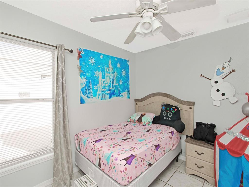 6936 Needle Point Drive Orlando, FL 32822 - Photo 16 of 29 a bedroom with a bed and a window