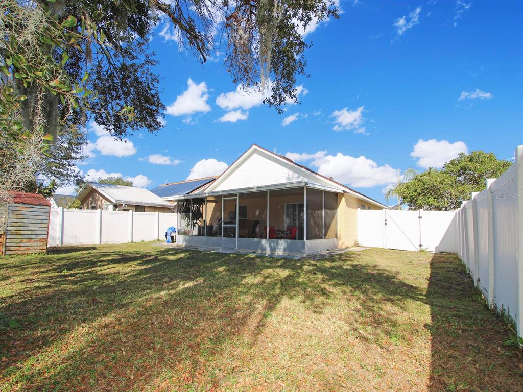 6936 Needle Point Drive Orlando, FL 32822 - Photo 20 of 29 a view of a house with a yard