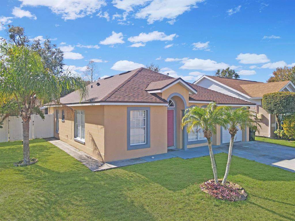 6936 Needle Point Drive Orlando, FL 32822 - Photo 2 of 29 a view of a house with a yard