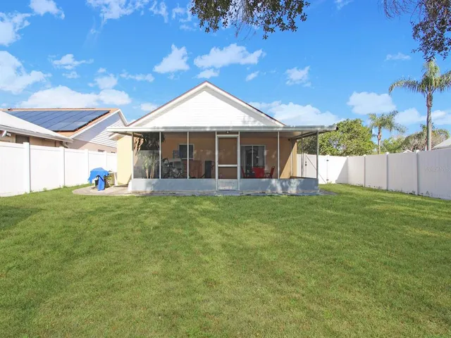 a view of a house with a backyard