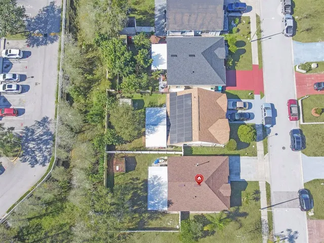 an aerial view of residential building with green space