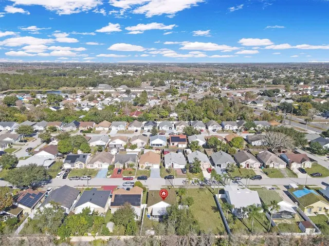 an aerial view of residential house with outdoor space and swimming pool