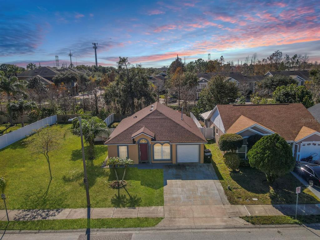 6936 Needle Point Drive Orlando, FL 32822 - Photo 29 of 29 a front view of a house with a yard