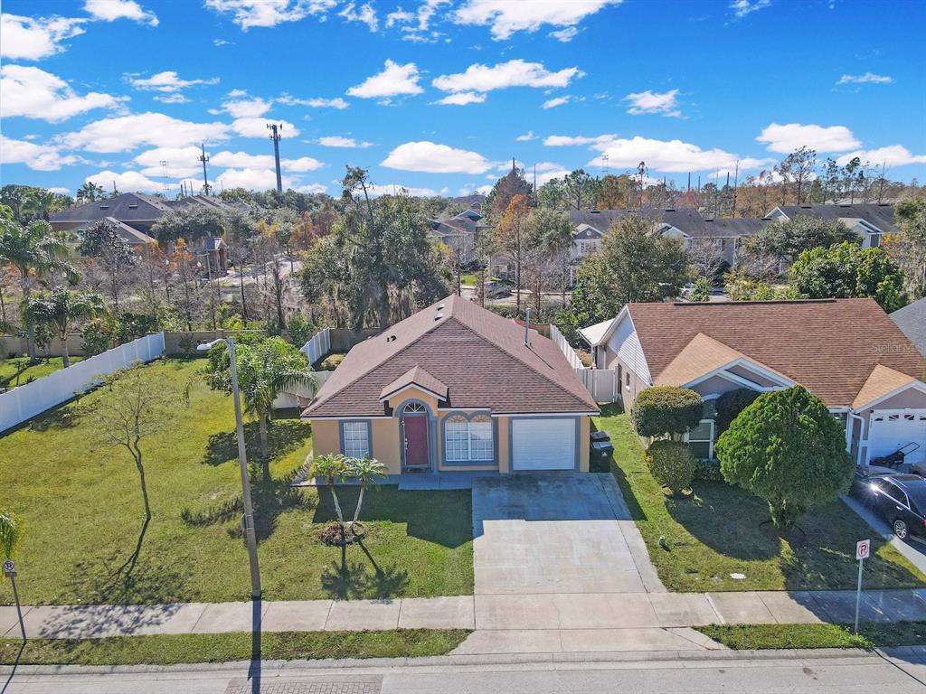 6936 Needle Point Drive Orlando, FL 32822 - Photo 3 of 29 a front view of a house with a yard