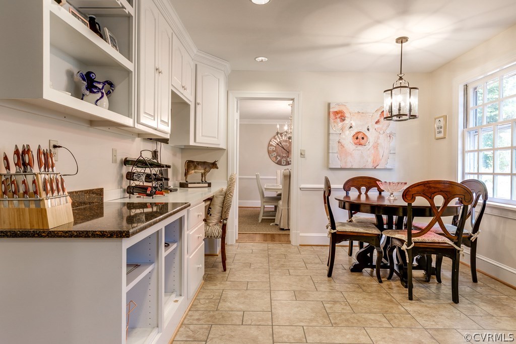 10300 Apache Road Richmond, VA 23235 - Photo 14 of 48 a kitchen with stainless steel appliances granite countertop a table chairs in it and a wooden floors