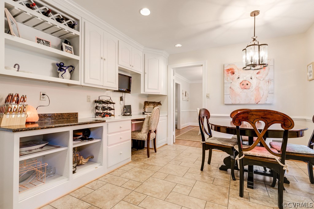 10300 Apache Road Richmond, VA 23235 - Photo 19 of 48 a kitchen with stainless steel appliances granite countertop a stove a sink dishwasher a dining table and chairs with cabinets