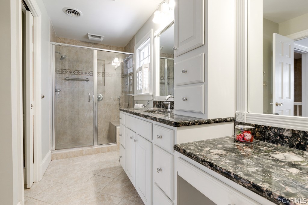 10300 Apache Road Richmond, VA 23235 - Photo 34 of 48 a bathroom with a granite countertop sink and a mirror