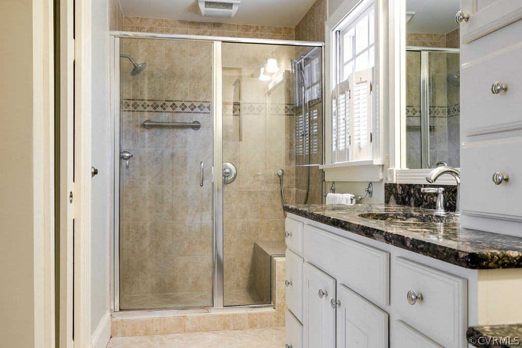10300 Apache Road Richmond, VA 23235 - Photo 39 of 48 a bathroom with a granite countertop shower a sink and mirror