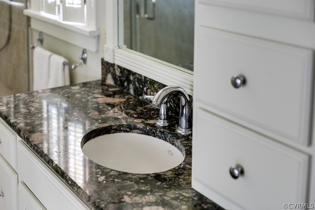 10300 Apache Road Richmond, VA 23235 - Photo 45 of 48 a bathroom with a sink and mirror