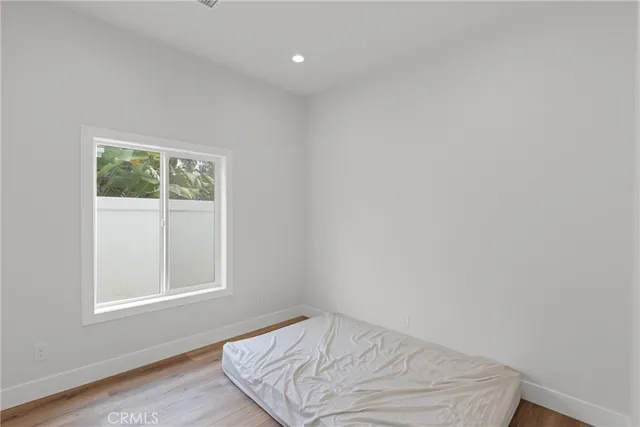 a view of room with window and hardwood floor