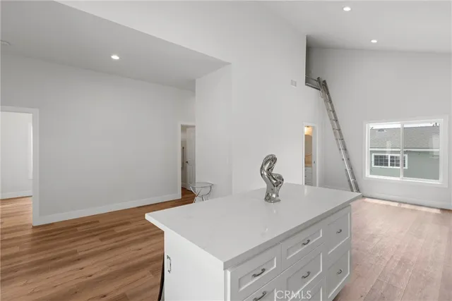 a kitchen with a sink cabinets and wooden floor