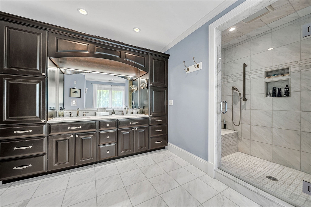 24 Summit Road Wellesley, MA 02482 - Photo 13 of 27 a large bathroom with a large mirror vanity and shower