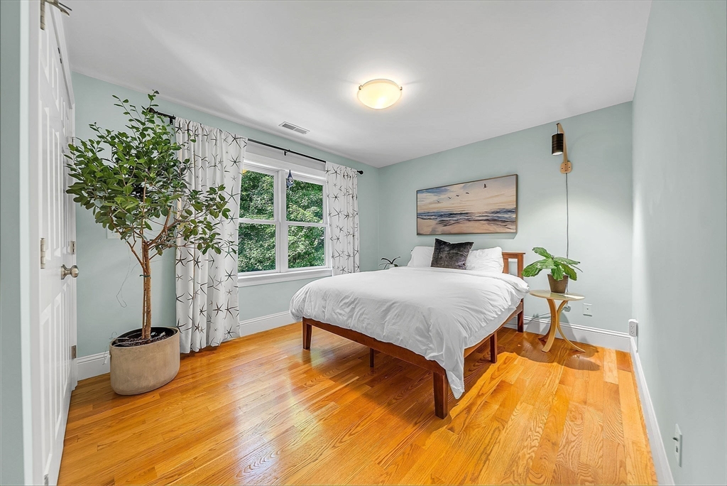24 Summit Road Wellesley, MA 02482 - Photo 18 of 27 a bedroom with a bed and wooden floor