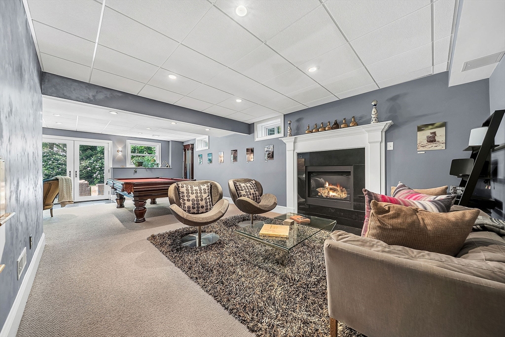 24 Summit Road Wellesley, MA 02482 - Photo 20 of 27 a living room with furniture a fireplace and a large window