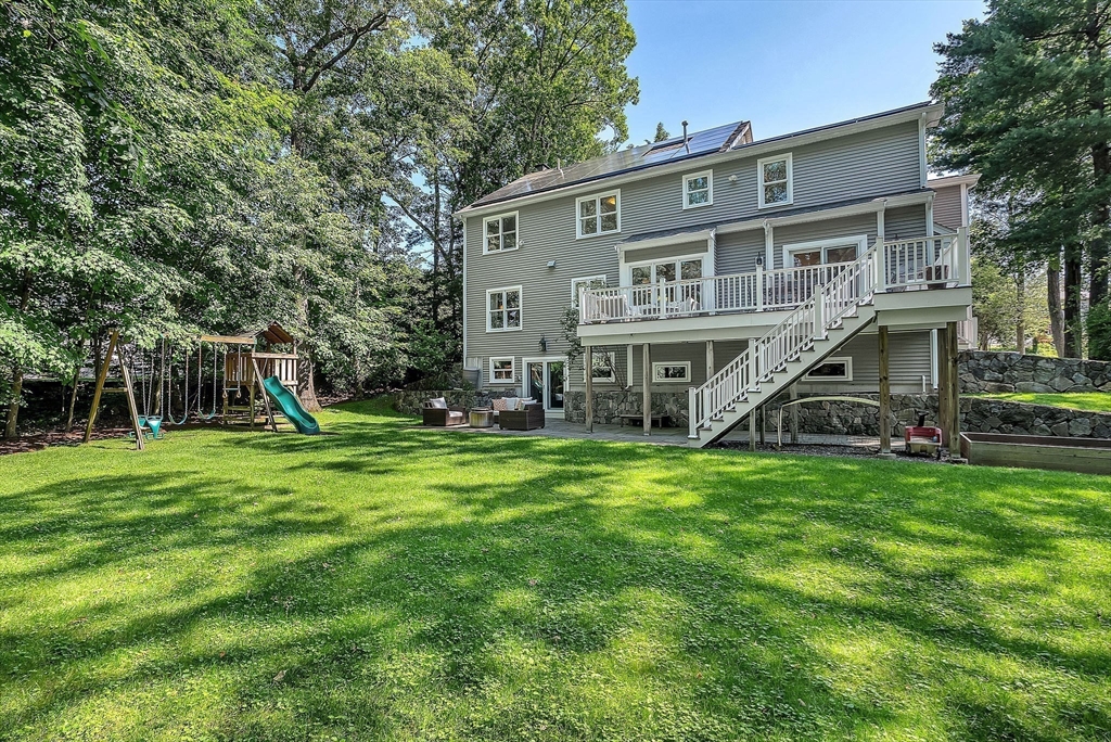 24 Summit Road Wellesley, MA 02482 - Photo 27 of 27 a view of a house with a big yard and potted plants and large trees