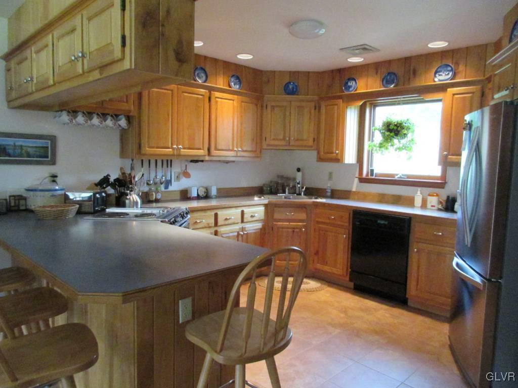 541 Roberts Road Nazareth, PA 18064 - Photo 3 of 6 a kitchen with stainless steel appliances granite countertop a sink a stove a refrigerator cabinets and dining table