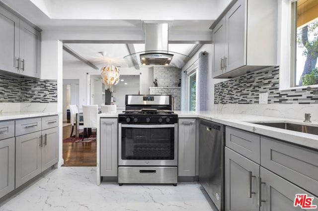 a kitchen with stainless steel appliances cabinets and a counter